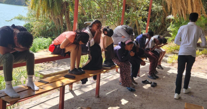 People praying on a bench