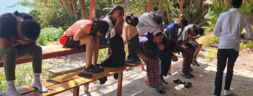 People praying on a bench
