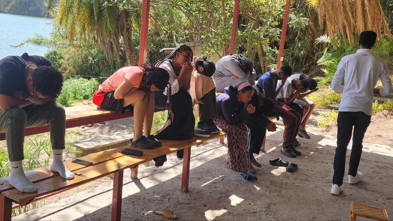 People praying on a bench