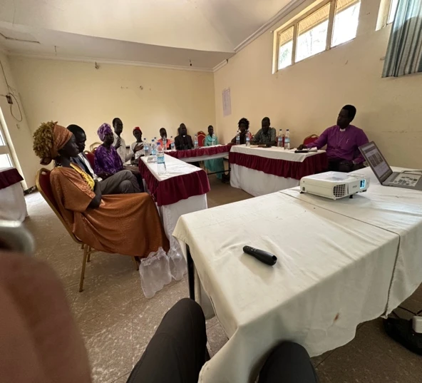People in a workshop around three tables