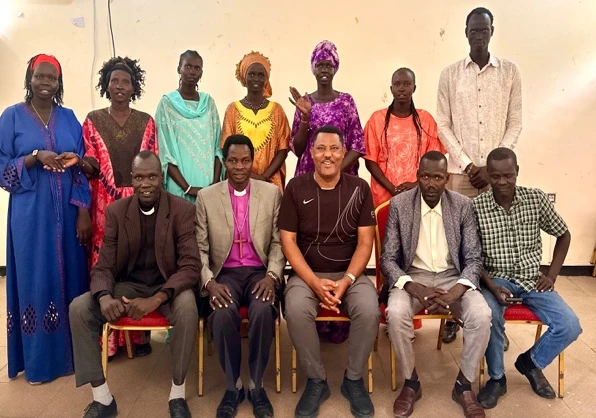 People in a workshop posing for a picture