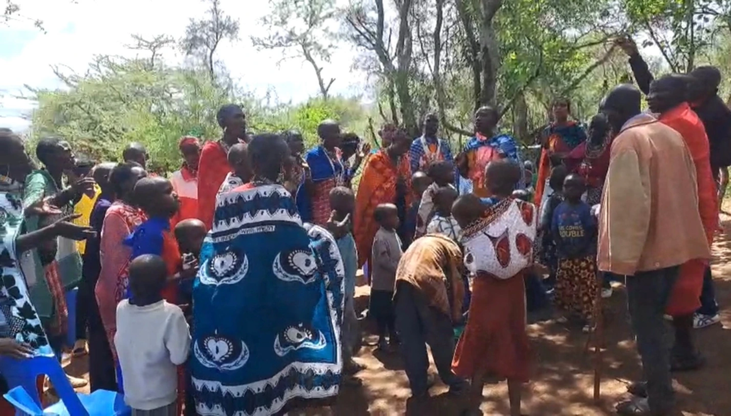 Church service, believers worshiping joyfully under a tree in Kenya