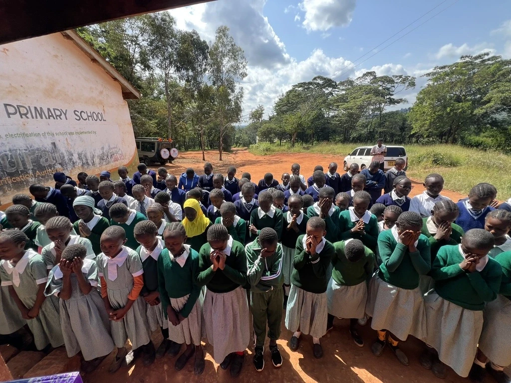 Different school girls praying at their respective schools in Kenya