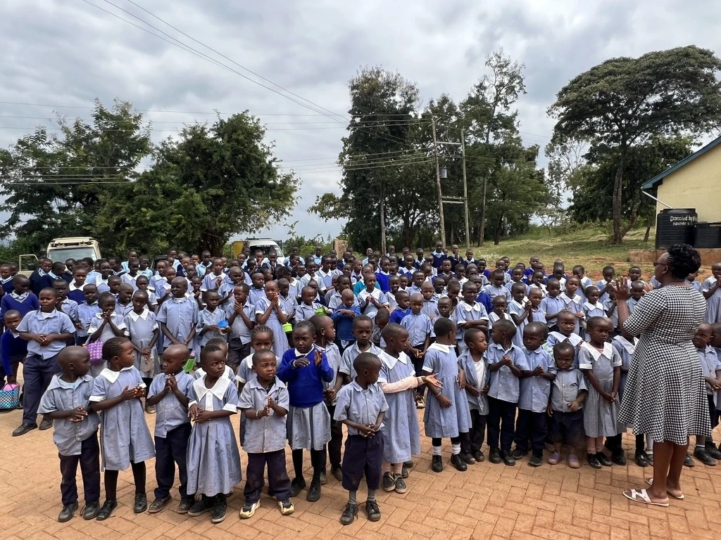Different school girls receiving dignity pads at their respective schools in Kenya